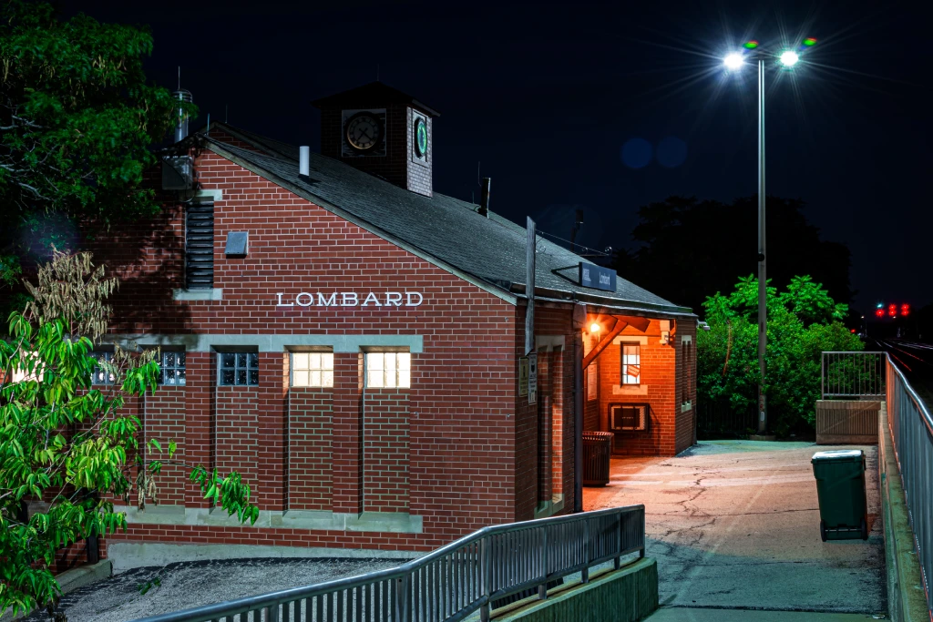 Lombard Illinois Metra Train Station Depot at Night with Clock Tower.jpg