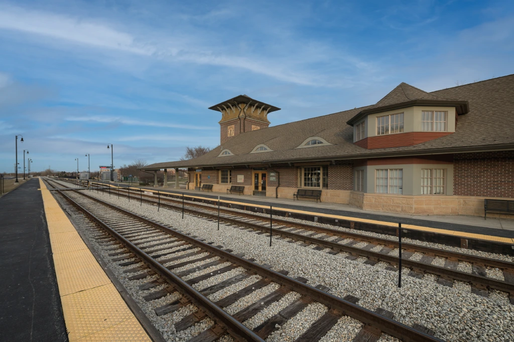 Suburban Metra Train Station Platform with Brick Depot and Rail Tracks.jpg