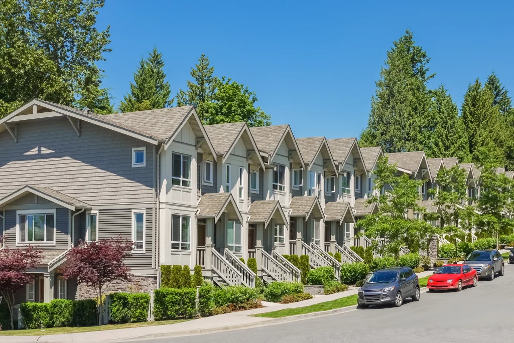 Suburban Townhome Row with Gabled Roofs Covered Entrances and Street Parking.jpg